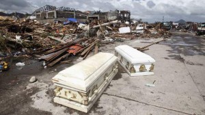 Empty coffins lie on a street near houses damaged after super Typhoon Haiyan battered Tacloban city