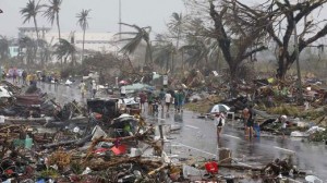 Residents walk on a road littered with debris after Super Typhoon Haiyan battered Tacloban city in central Philippines